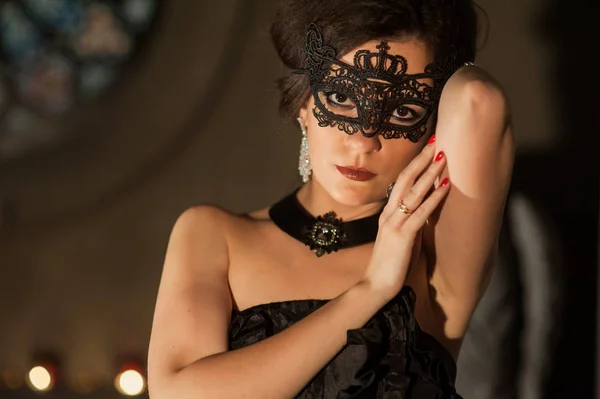 woman wearing black party mask
