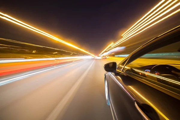 Uitzicht vanaf zijkant van de auto bewegen in een nacht stad — Stockfoto