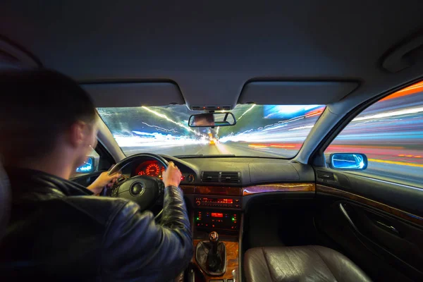 Driver in car moves at fast speed at night. — Stock Photo, Image