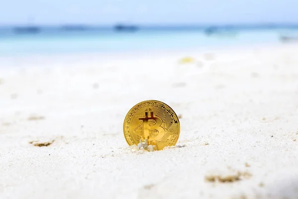 Golden Bitcoins on a beach sand — Stock Photo, Image