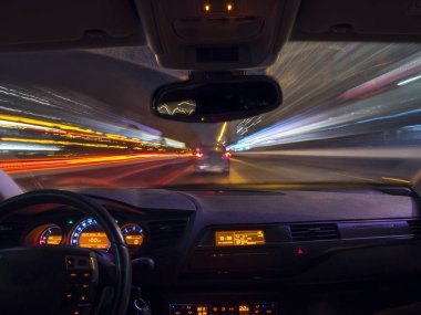 A car driving on a motorway at high speeds, overtaking other cars clipart