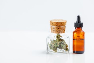 Medical Marijuana In Glass Jar Cannabis Oil Extract In Bottle Is clipart
