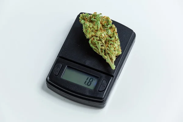 Marijuana Cannabis Bud Weighed On Digital Electronic Scale. Sele