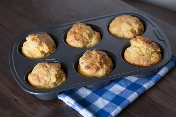 Corn Bread Muffins In Muffin Pan On Country Distressed Wood Table