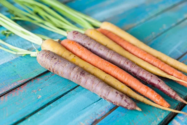 Organic Raw Carrots On Colorful Blue Wood Texture Table Background — Stok Foto