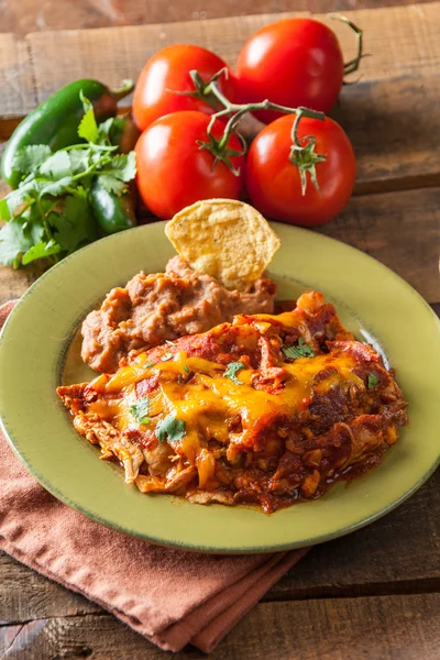 Chicken Enchilada Mexican Food Casserole Served On Rustic Green Plate — Stock Image Chicken Enchilada Mexican Food Casserole Served On Rustic Green Plate Stock Picture