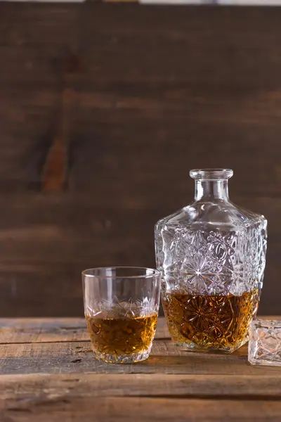 Whiskey in glass on wood background — Stock Photo, Image