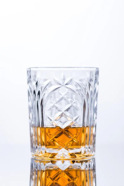 Whisky op de rotsen op de glazen tafel — Stockfoto