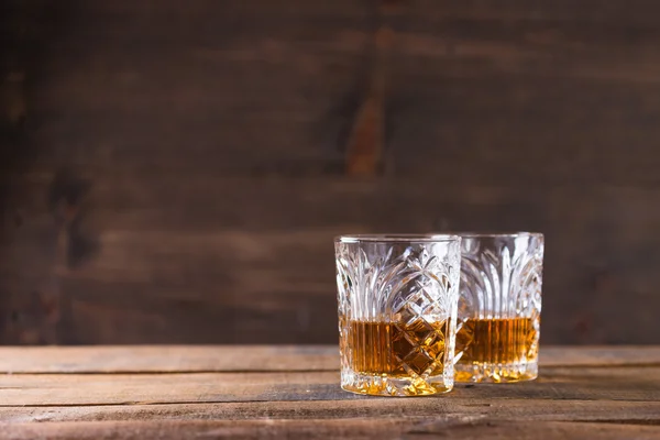Whiskey in glass on wood background — Stock Photo, Image
