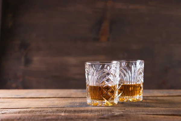 Whiskey in glass on wood background — Stock Photo, Image