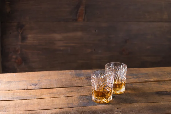 Whiskey in glass on wood background — Stock Photo, Image