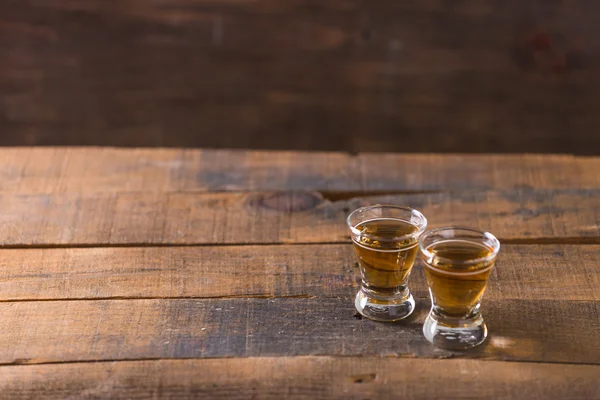 Whiskey in glass on wood background — Stock Photo, Image