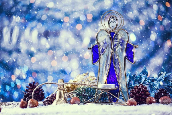Snow Falling On Christmas Angel Candle With Decor. Vintage Filter Applied.