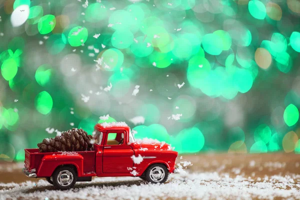 stock image Christmas Toy Truck With Pine Cone And Snow Falling On Wood