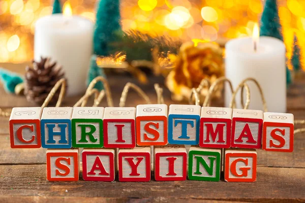 Christmas Saying Written With Toy Blocks On Holiday Card Background — Stock Photo, Image