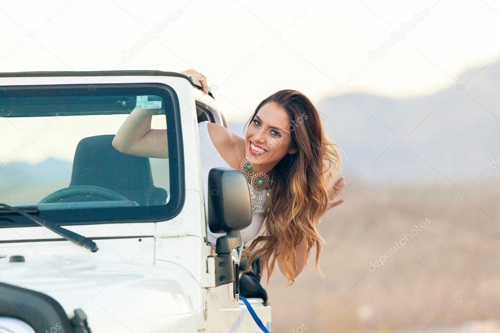 Happy Smiling Young Woman In Convertible Car Hanging Out Window 