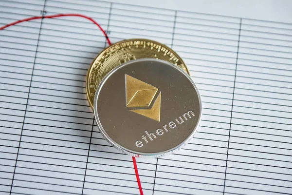 Pile of gold ethereum cryptocurrency coin on stock market line table. — Stock Photo, Image