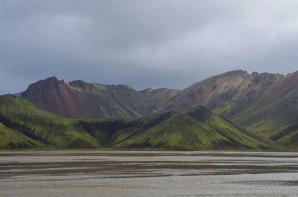 Lake and moss-covered volcanic mountains. Landmannalaugar. Iceland Stock Picture