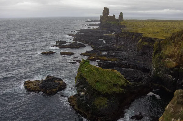 Atlantic ocean and black rock cliff of western Iceland coast, Snaefellsnes Peninsula, Iceland