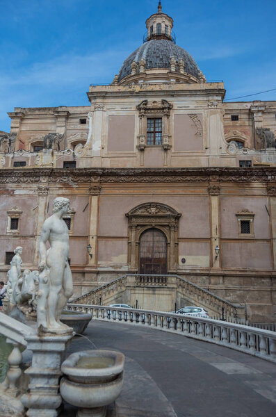 Baroque fountain with nude figurines on piazza Pretoria and  church Chiesa di Santa Caterina at background. Palermo Italy.