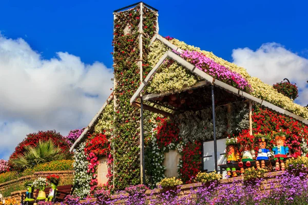 stock image Floral house and dolls on the bench