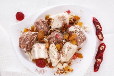 Helva, Kuru Kayısı, Kuru üzüm, ceviz, churchchel, pudra şekeri marmelat. Bir plaka üzerinde oryantal tatlılar