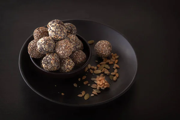 Healthy organic energy granola bites with nuts, cacao, banana and honey - sports food, vegetarian raw snack