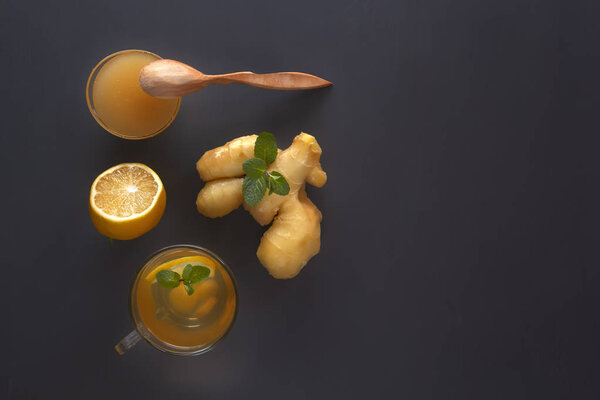 Имбирный чай с лимоном, медом и мятой на сером деревянном столе. Принято. Вид сверху

