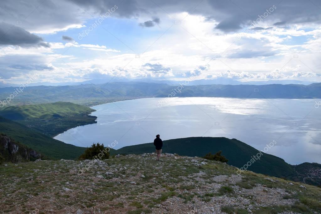 Man standing in viewpoint on Ohrid Lake, top view. Podgradec, Albania - Macedonia border.