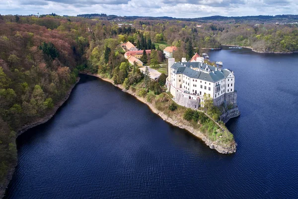 Aerial view on czech romantic, gothic chateu Orlik, situated on rock outcrop above Orlik reservoir in beautiful spring nature. Romantic,royal Schwarzenberg castle above water level. Czech landscape. — Stock Photo, Image