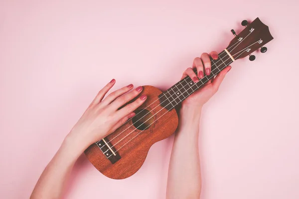 Kadınlar küçük ukulele tutarlar