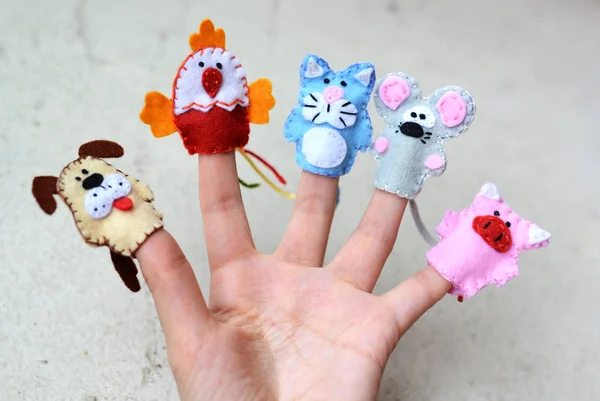 Hand wearing 5 finger puppets
