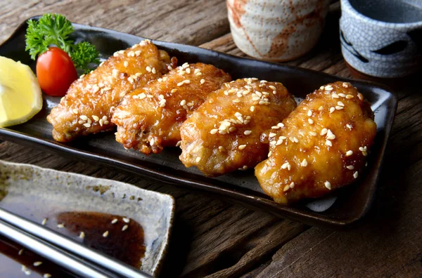 Fried chicken wing with spicy sauce in Japanese tebasaki style.