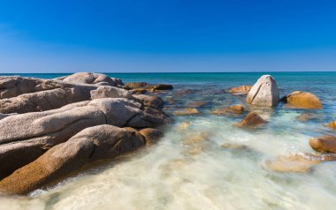 Lanscape view of white stones in blue sea.