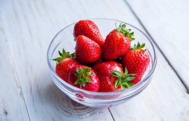 Kahvaltı için Beyaz ahşap zemin üzerinde plaka üzerinde çilek 