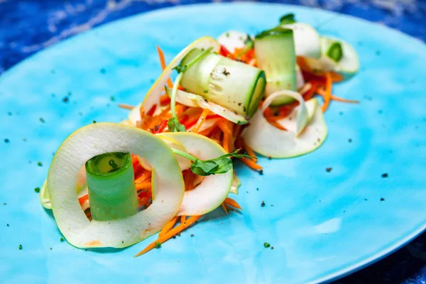 Spring vegetable fitness salad with apple, carrot, cucumber and  pepper in a restaurant feeding from chef