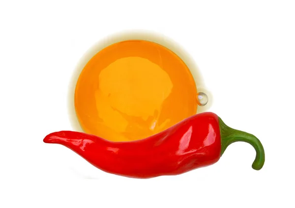 Chicken egg yolk and pepper on a white background. — Stock Photo, Image