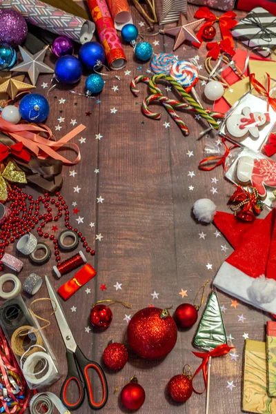 2019.12.28, Moscow, Russia. Work area on the table for the preparation of gifts for the New Year\'s Eve. Work mess chaos on Christmas Eve.