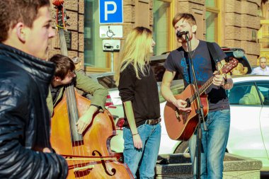2015.04.12, Moscow, Russia. Street musicians at spring day. Trio band of young artists at the street performance.