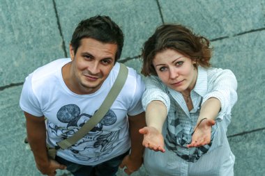 2011.05.21, Moscow, Russia. Funny posed young guy and girl close up. Two young people having fun, top of view.