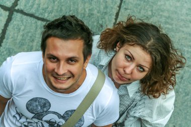 2011.05.21, Moscow, Russia. Funny posed young guy and girl close up. Two young people having fun, top of view.