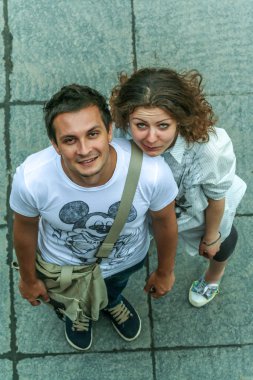 2011.05.21, Moscow, Russia. Funny posed young guy and girl close up. Two young people having fun, top of view.