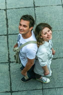 2011.05.21, Moscow, Russia. Funny posed young guy and girl close up. Two young people having fun, top of view.