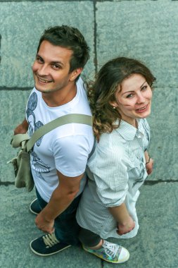 2011.05.21, Moscow, Russia. Funny posed young guy and girl close up. Two young people having fun, top of view.