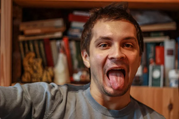 Young Attractive Man Looking Camera Showing Tongue Guy Sitting Library — Stock Photo, Image