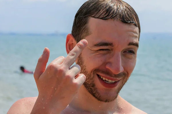 Young Bearded Man Shows Middle Finger While Looking Camera Background — Stock Photo, Image