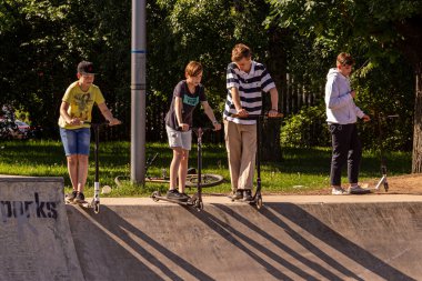 26.05.2018, Moskova, Rusya. Farklı yaşlarda bir grup çocuk kaykay parkında scooter kullanıyor. Modern Rus çocuklarının aktif yaşam tarzı.