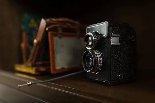 Old camera on wooden cupboard