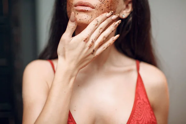 Coffee scrub on the woman face
