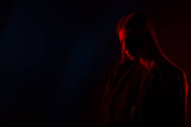 Kırmızı ışıkta poz veren, sıradan kıyafetli güzel bir kadın.